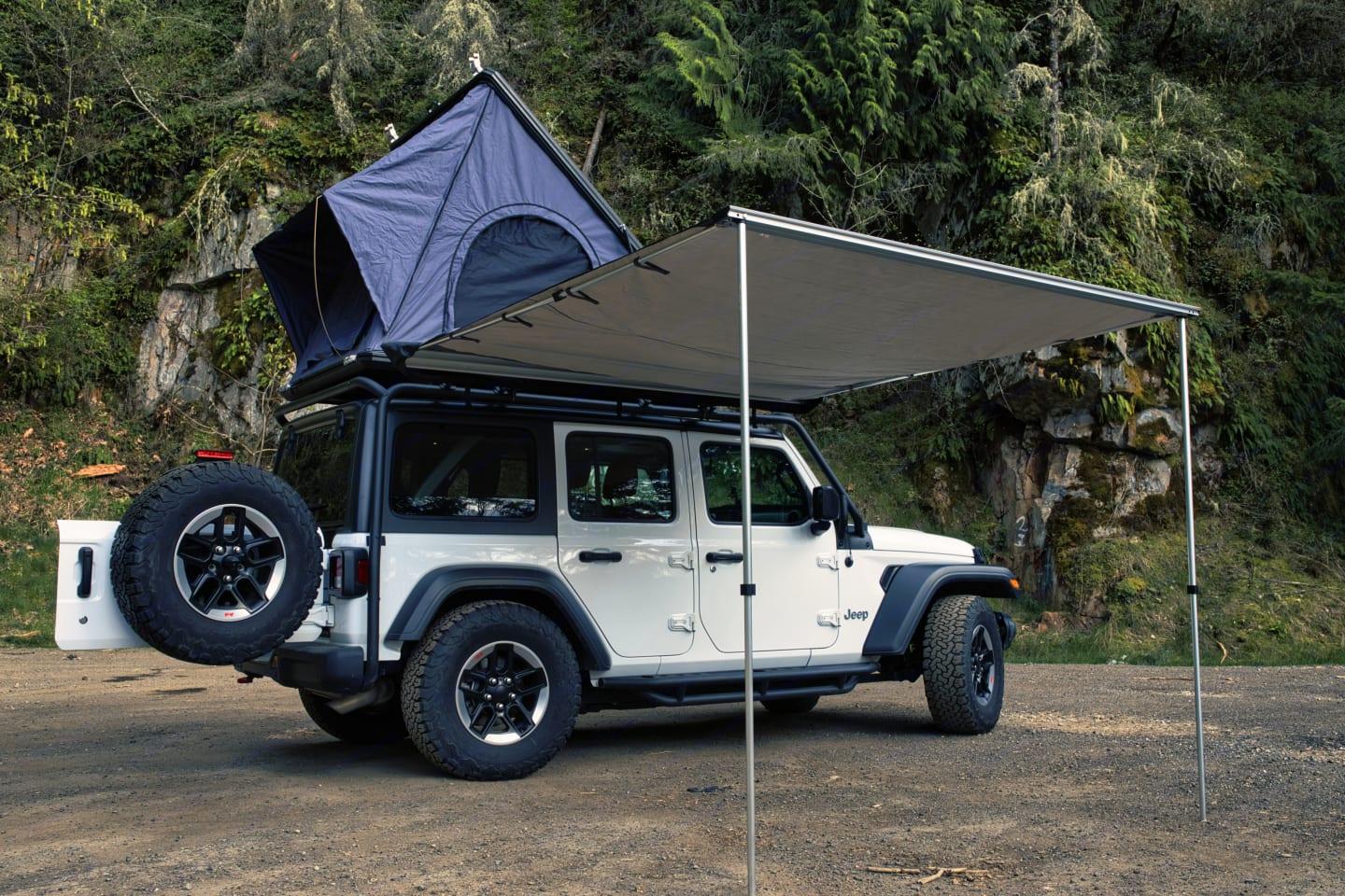 Jeep Wrangler with its side awning extended at a forest pull-out